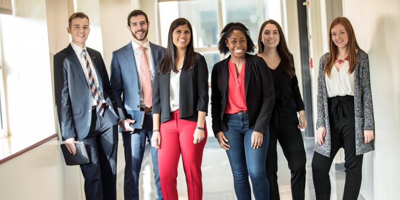 Six students standing in Schoenbaum Hall hallway