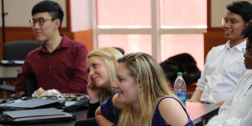 DLA students talking at tables with their group