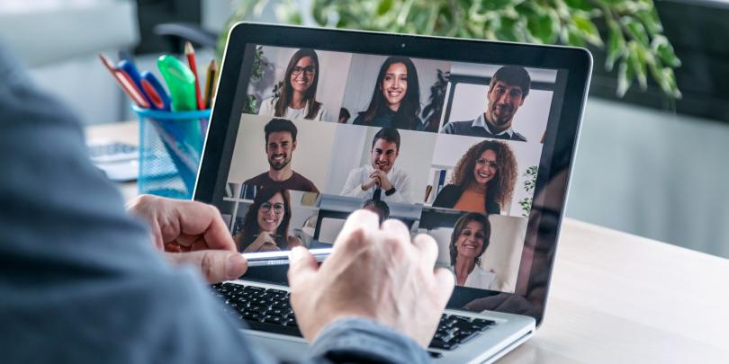 Laptop screen with people on webcam