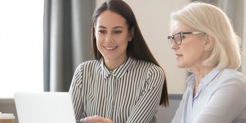 Two women looking at a computer
