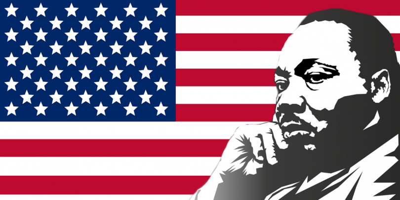 Martin Luther King, Jr. in front of American flag