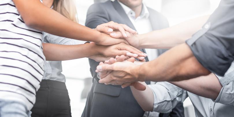People stacking hands together
