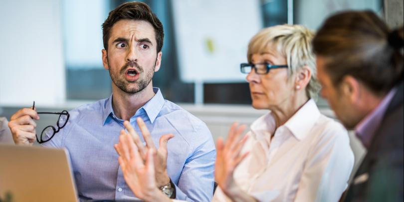 Man looking angry in office meeting