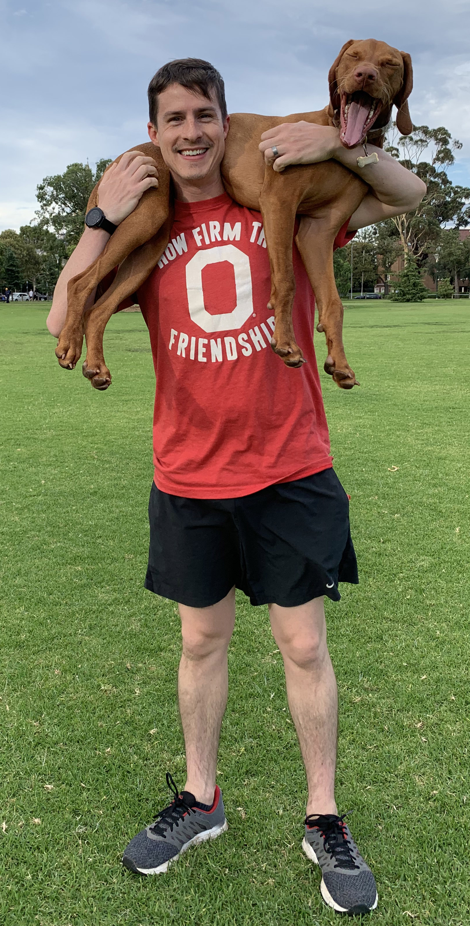 Josh Meyer in Ohio State t-shirt with his dog, Kaizen
