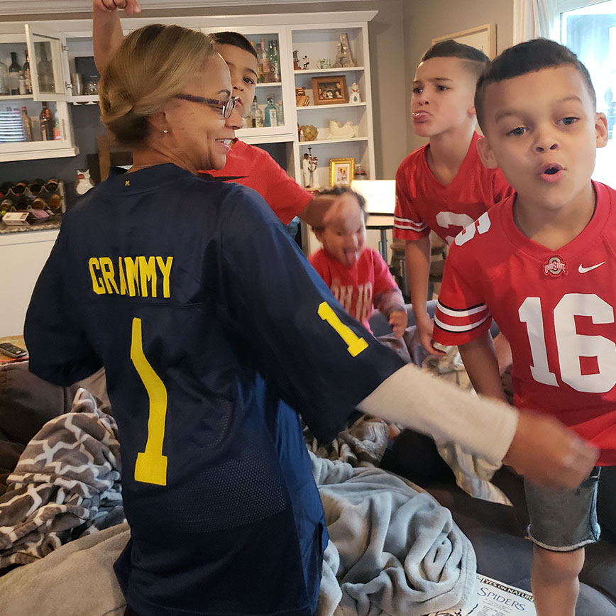 Elicia Azali's children "boo" and jeer their Grammy who is wearing a University of Michigan football jersey