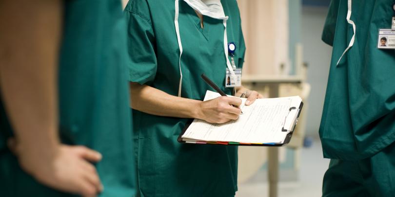 Stock image of a doctor holding a medical chart