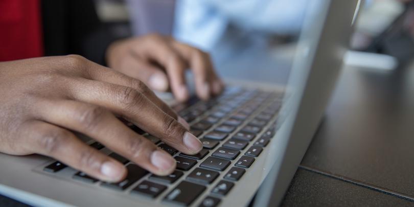 Stock image of a student working on a laptop