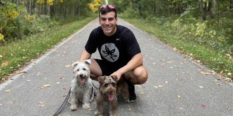 Cole Williams on a path with two dogs