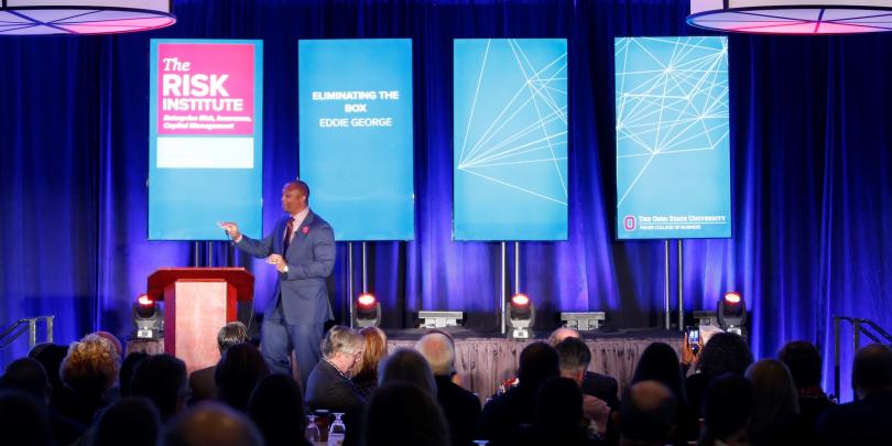 Eddie George speaking at annual conference